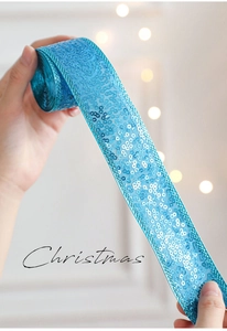 Detail of blue sequin ribbon for Christmas gift wrapping and festive decoration