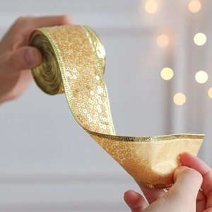Glittering gold sequin ribbon roll for Christmas gift wrapping and festive decoration
