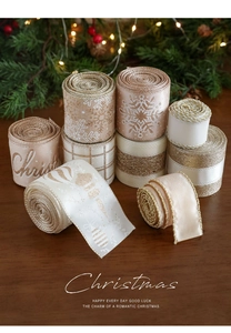 Close-up of champagne Christmas ribbons with snowflake patterns on a rustic wooden table
