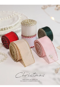 Detail of Christmas satin ribbon rolls in various colors with metallic woven gold edges