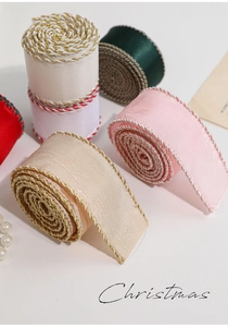 Close-up of decorative Christmas satin ribbons with metallic woven edges in assorted colors