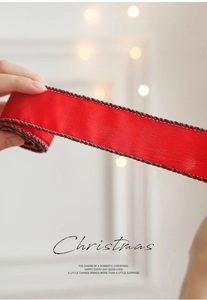 Detail of red Christmas ribbon with twisted green and black rope edge for gift wrapping