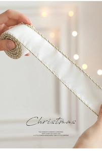 Macro shot of white satin Christmas ribbon with shimmering gold and silver woven edges