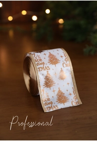 Macro detail of white Christmas ribbon with gold tree patterns and festive lettering