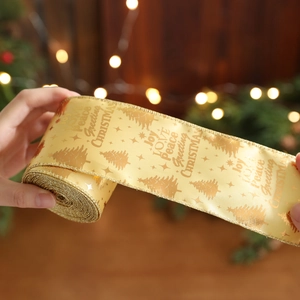 Golden Christmas ribbon with foil-stamped trees and greetings for festive gift wrapping