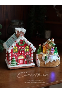 Close-up of glowing LED Christmas gingerbread house with rotating festive music box details