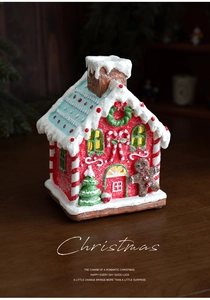 Close-up of a glowing Christmas gingerbread house with festive LED lights and snowman