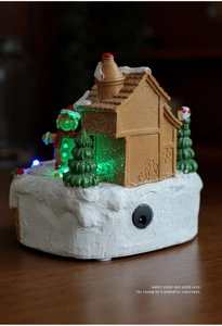 Detailed view of LED glowing gingerbread house with snow base and DC power port