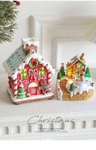 Luminous resin Christmas gingerbread house ornaments with warm LED lighting and music box detail