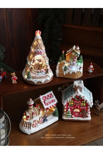 Macro detail of lighted resin gingerbread house and cake shop train Christmas decor