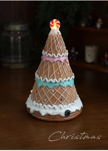 Close-up of a gingerbread style Christmas house with LED lights and candy decor