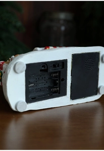 Detailed base view of Christmas house music box showing battery slot and switch functions