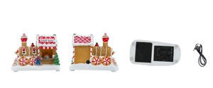 Detail view of resin Christmas gingerbread house train with USB cable and battery slot