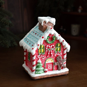 Luminous Christmas gingerbread house decoration with warm LED lights and resin finish