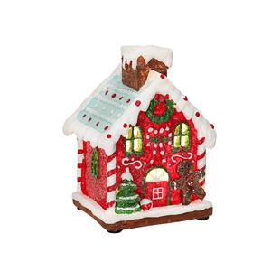 Luminous Christmas gingerbread house with warm lights, fake snow, and gingerbread man decor