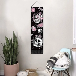 Skull and floral tapestry wall hanging with moon and crystal motifs in modern interior