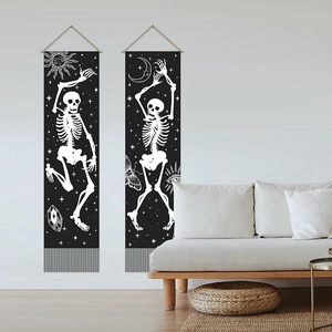 Modern black tapestry set with white skull and moon motifs featuring grey tassels for decor