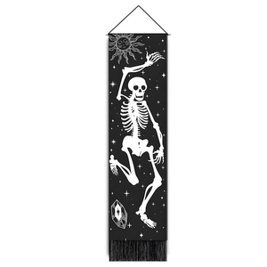 Vertical black tapestry with white dancing skeleton, sun motif, and decorative tassels