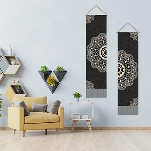 Set of two black bohemian mandala tapestries hanging in a modern living room setting