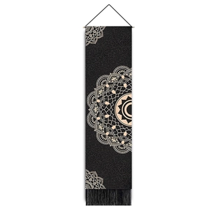Detailed view of bohemian black mandala tapestry with tassels and hanging rod