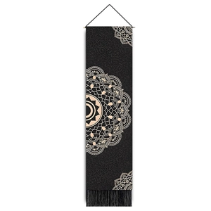 Macro view of bohemian mandala tapestry featuring elegant black fabric and hanging tassels