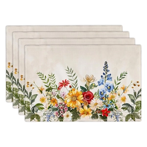 Close-up of four linen placemats with colorful sunflower and wildflower prints
