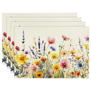 Detailed view of four linen placemats with colorful watercolor wildflower patterns