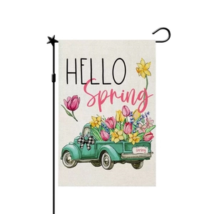 Garden flag detail showing a green vintage truck with spring flowers and metal stand