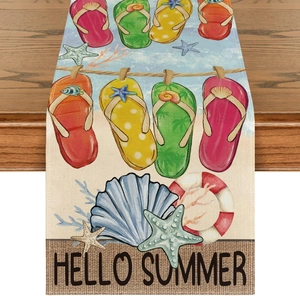 Detail of linen table runner with Hello Summer flip-flops and seashells print on wood