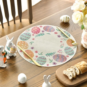 Close-up of Easter round linen placemat with colorful eggs and floral patterns on wood table