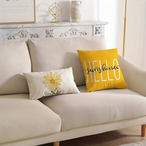 Yellow Hello Sunshine and daisy floral throw pillows on a cream sofa for home decor