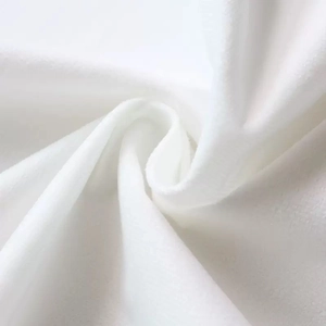 Close-up of soft white flannel velvet fabric texture showing plush pile and premium quality