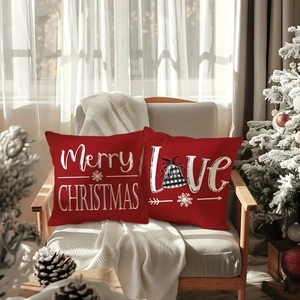 Detail of red Merry Christmas and Love linen pillow covers on a cozy armchair
