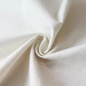Close-up of beige linen pillowcase fabric with rustic daisy pattern and woven texture