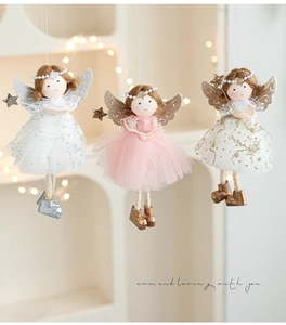 Detailed view of plush angel girl dolls with glitter wings and sequin dresses