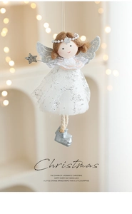 Detail of plush Christmas angel doll with white sequin dress and silver wings ornament