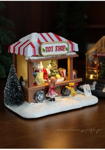 Close-up of a festive Christmas toy shop miniature with Santa Claus and snow details