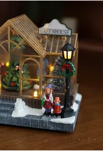 Detail of Christmas greenhouse resin ornament with glowing street lamp and fake snow