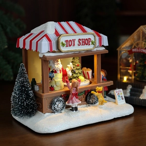 Lighted resin Christmas toy shop house with LED light, Santa figure and snow decor