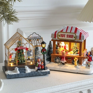 Lighted resin Christmas toy shop and snow-covered glass house festive desktop decor