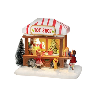 Lighted Christmas toy shop resin miniature with Santa Claus and kids on white background