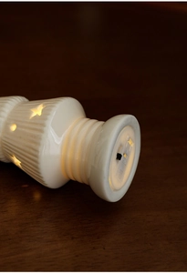 Detailed base view of ceramic Christmas tree lamp showing power switch and star cutouts