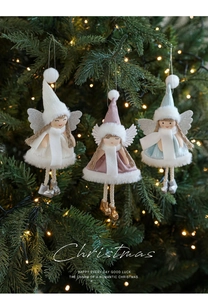 Detail of Christmas plush angel doll ornaments hanging on a tree with warm lights