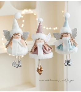 Three plush Christmas angel dolls in white, pink, and blue hanging from woven ropes