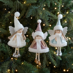 Three plush angel Christmas tree ornaments in white, pink and blue with glitter wings