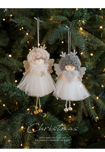 Detail of plush angel girl ornaments with glitter antlers on a lit Christmas tree