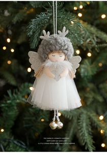 Close-up of plush Christmas angel ornament with silver antlers and sequins heart detail