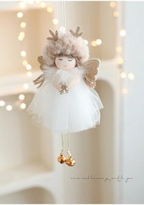 Detail of plush Christmas angel doll with pink reindeer antlers and gold bells