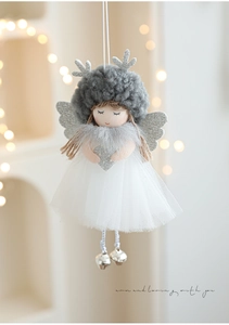 Detail of plush angel ornament with silver antlers, mesh skirt, and metal bells