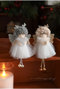 Detailed view of plush angel dolls with silver reindeer antlers and white mesh skirts